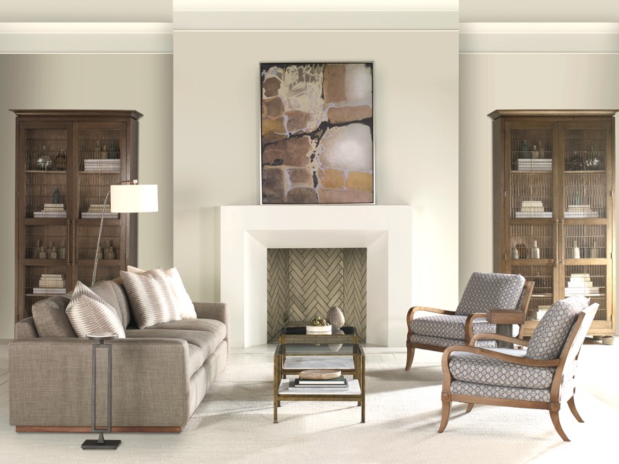 A living room with a fireplace and a couch. Subtle biophilic art and detail elements.